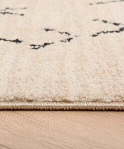 Tappeto berbero Beni Ouarain Sufian - Crema/Nero - close up zijkant, thumbnail Tappeto berbero Beni Ouarain Sufian - Crema/Nero - close up zijkant, thumbnail